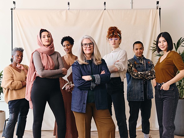 a group photo of 7 woman of varying ethic backgrounds and ages